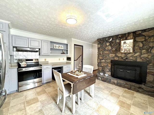 kitchen featuring a fireplace, ornamental molding, under cabinet range hood, gray cabinets, and stainless steel electric stove