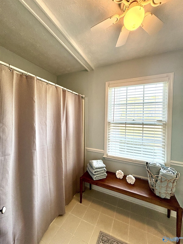 full bathroom featuring a textured ceiling, ceiling fan, and tile patterned floors