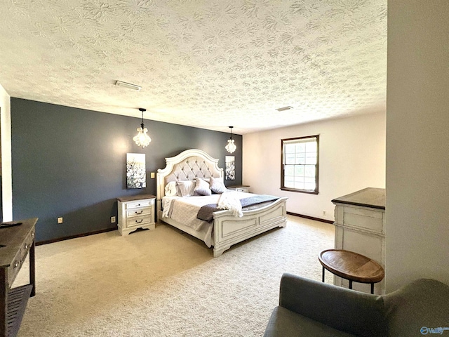 bedroom with a textured ceiling, baseboards, light colored carpet, and visible vents