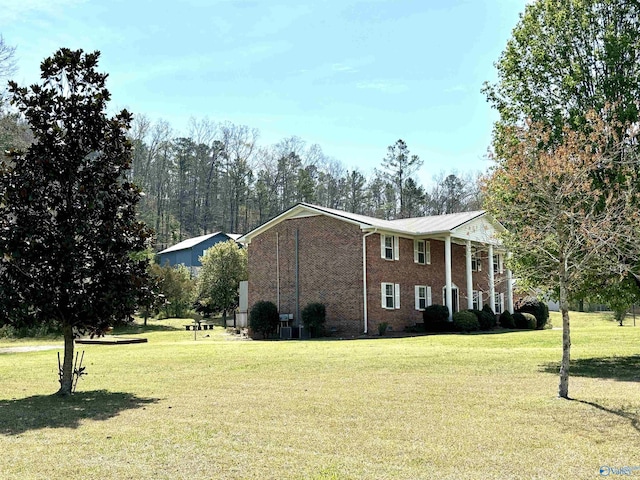 exterior space featuring a front lawn and brick siding