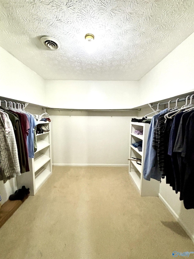 spacious closet featuring visible vents and carpet