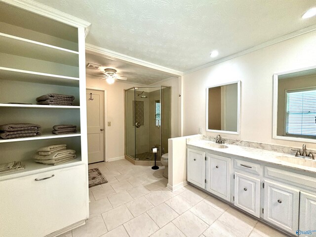 full bath with toilet, a sink, a stall shower, and double vanity