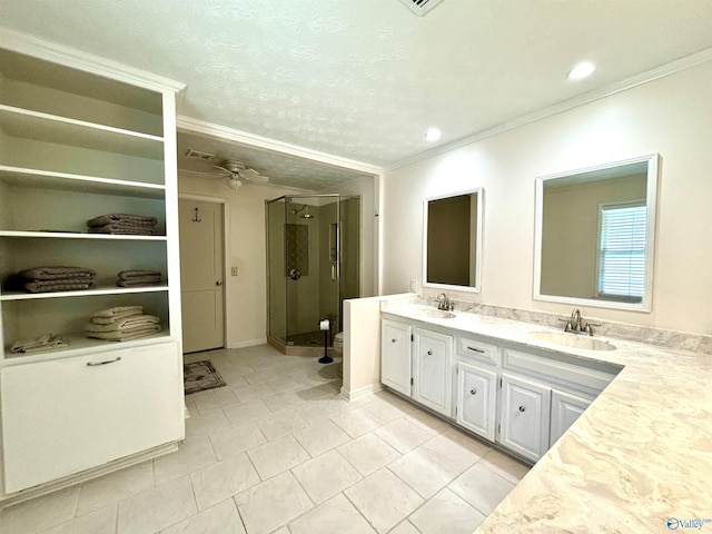 full bath featuring ornamental molding, a sink, and a shower stall