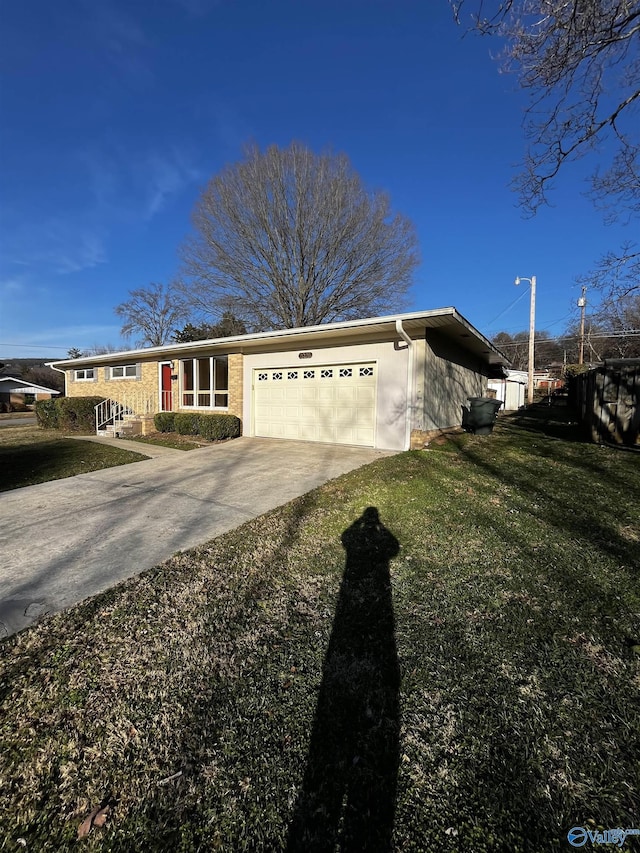 ranch-style house with a garage, concrete driveway, and a front lawn