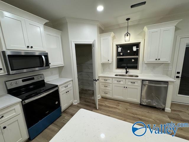 kitchen with white cabinetry, sink, and stainless steel appliances