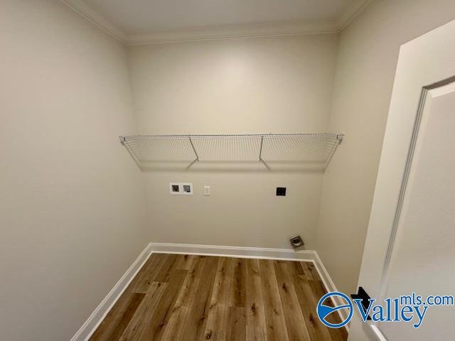 clothes washing area with crown molding, hardwood / wood-style floors, washer hookup, and hookup for an electric dryer