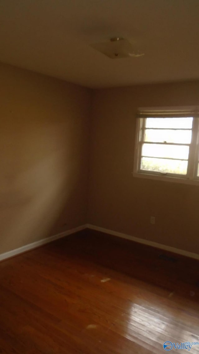 spare room featuring hardwood / wood-style floors