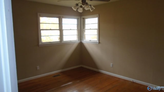 unfurnished room featuring ceiling fan, a healthy amount of sunlight, and wood-type flooring