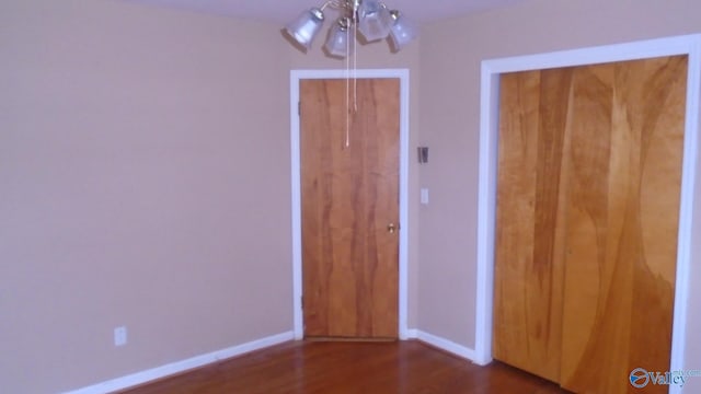 unfurnished bedroom with dark hardwood / wood-style floors