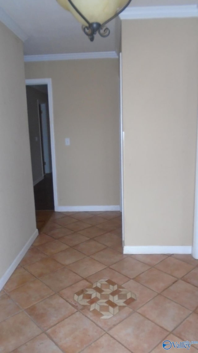 tiled spare room with ornamental molding