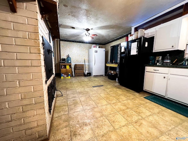 kitchen with black fridge, a textured ceiling, ceiling fan, white refrigerator, and white cabinets