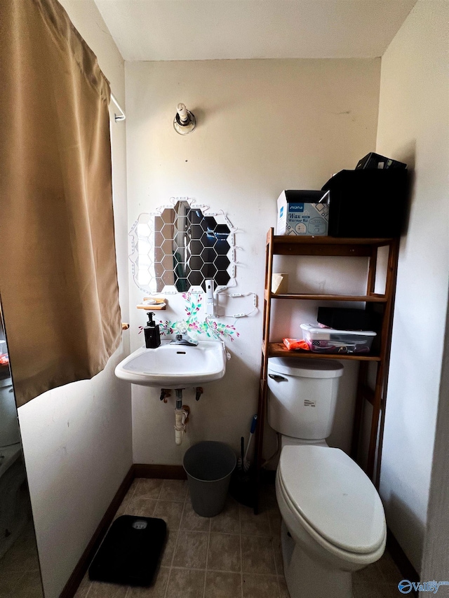 bathroom with tile patterned floors, sink, and toilet