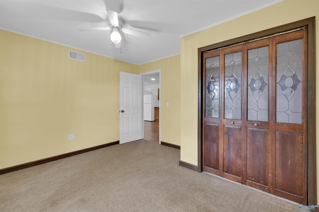 1073 6th St S, Sylvania, AL 35988 - unfurnished bedroom with light colored carpet, ornamental molding, freestanding refrigerator, and ceiling fan