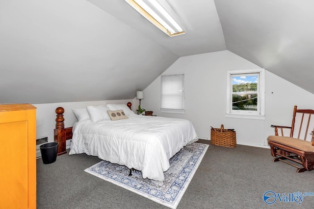 carpeted bedroom with lofted ceiling