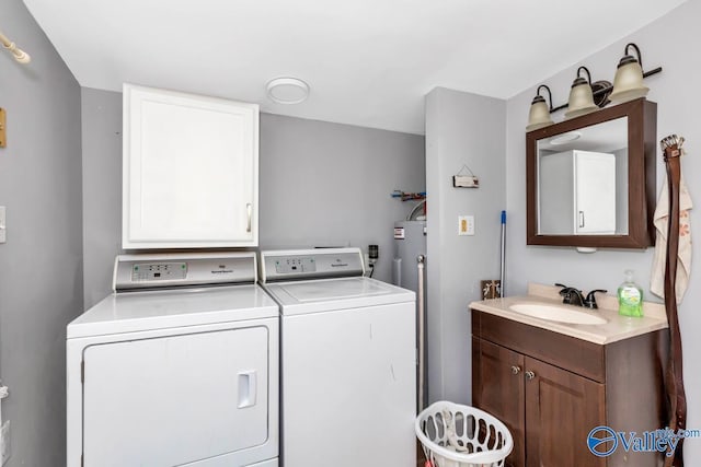 laundry area with cabinets, sink, and independent washer and dryer