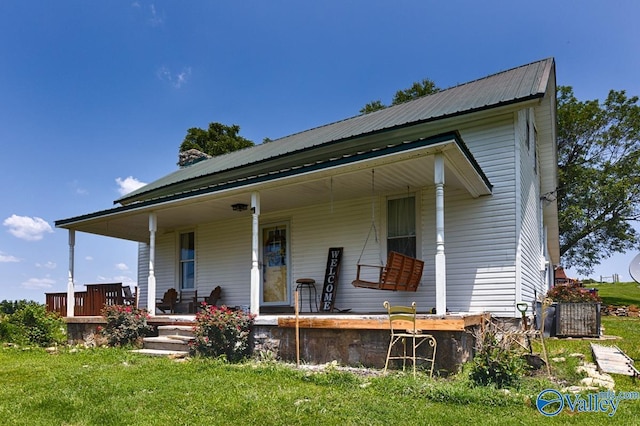 back of property with a porch