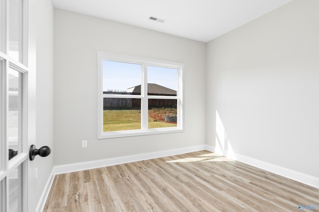 spare room featuring light hardwood / wood-style floors