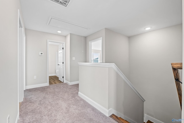 hallway featuring light carpet