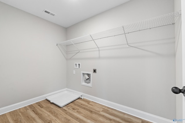 laundry area with hardwood / wood-style flooring, electric dryer hookup, and washer hookup