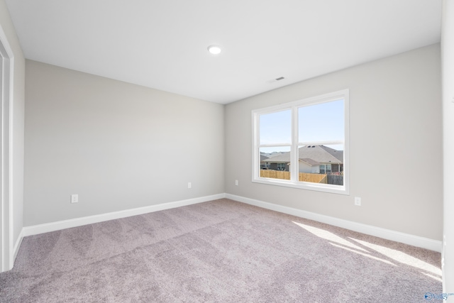 empty room featuring light colored carpet