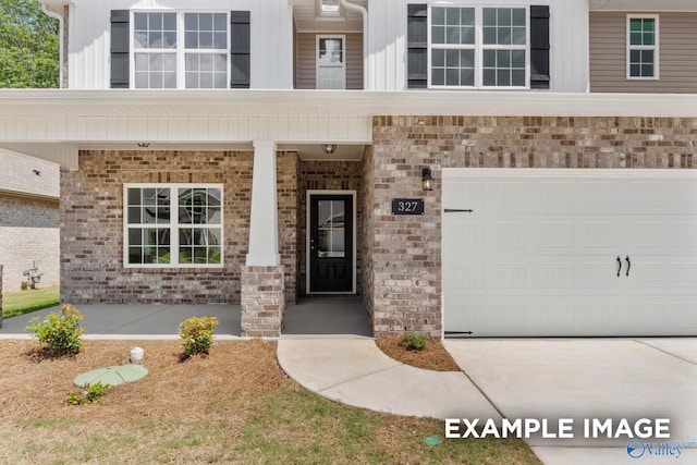 doorway to property featuring a garage and covered porch