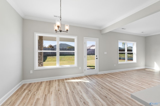 interior space featuring ornamental molding, light wood-type flooring, and a chandelier