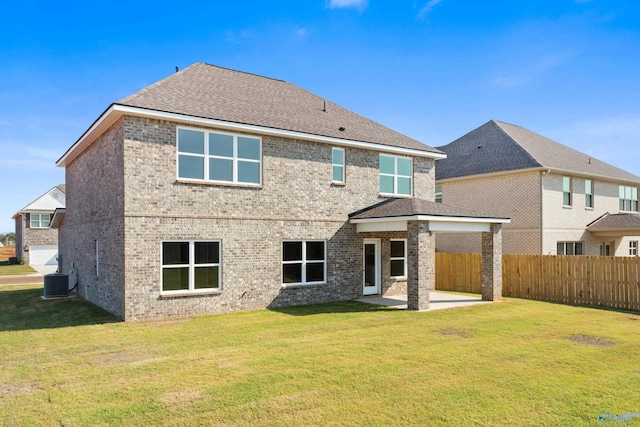 back of house with a patio, a lawn, and central air condition unit