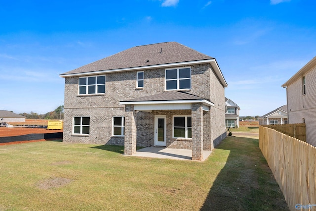 back of property featuring a yard and a patio