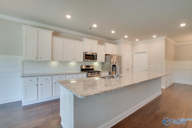 kitchen with stainless steel appliances, white cabinetry, tasteful backsplash, a center island with sink, and dark wood-type flooring