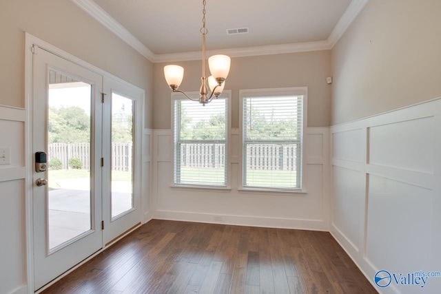 unfurnished dining area with a notable chandelier, a healthy amount of sunlight, and dark hardwood / wood-style floors