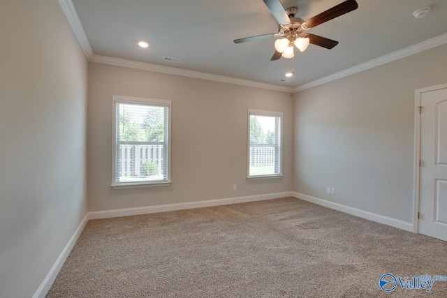 carpeted spare room with ceiling fan and crown molding