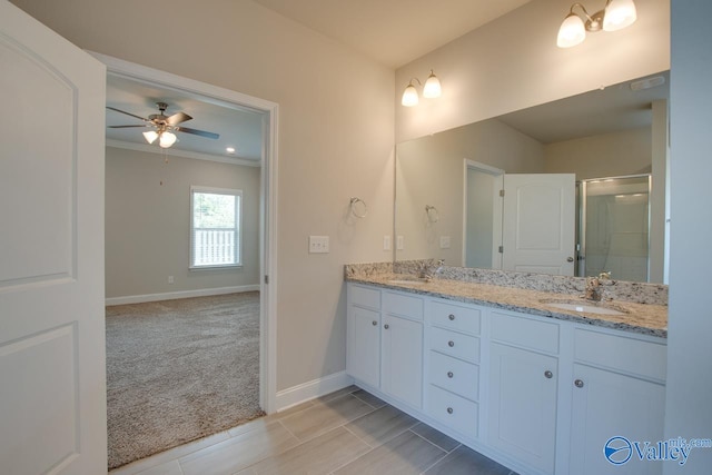 bathroom featuring ceiling fan, ornamental molding, double sink vanity, and tile patterned floors