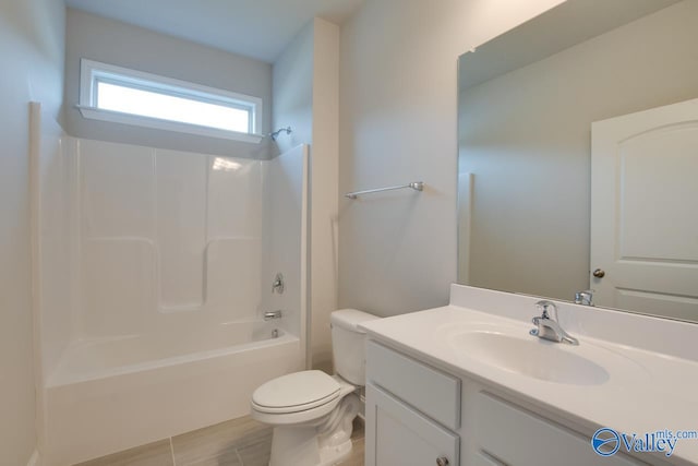 full bathroom with tile patterned flooring, vanity, tub / shower combination, and toilet