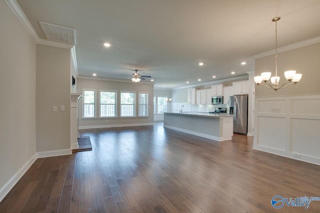 unfurnished living room with sink, crown molding, ceiling fan with notable chandelier, and dark hardwood / wood-style flooring