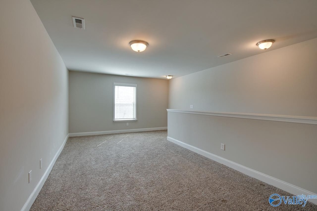 unfurnished room with light carpet