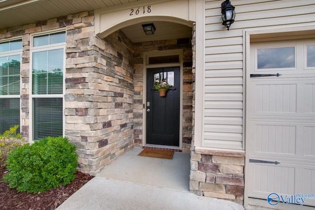 view of exterior entry featuring a garage