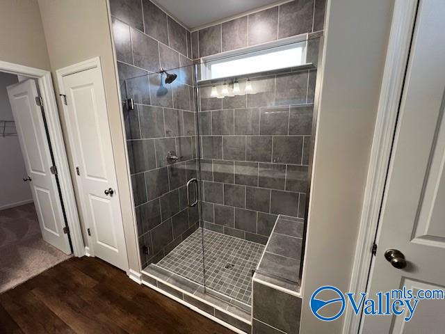 bathroom featuring wood-type flooring and walk in shower