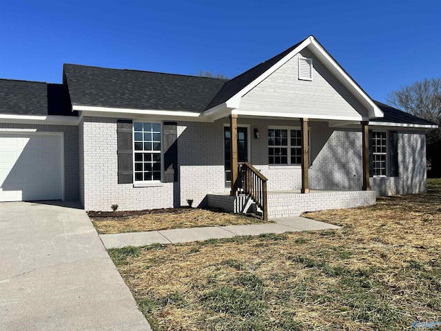 ranch-style house with a garage, brick siding, and covered porch