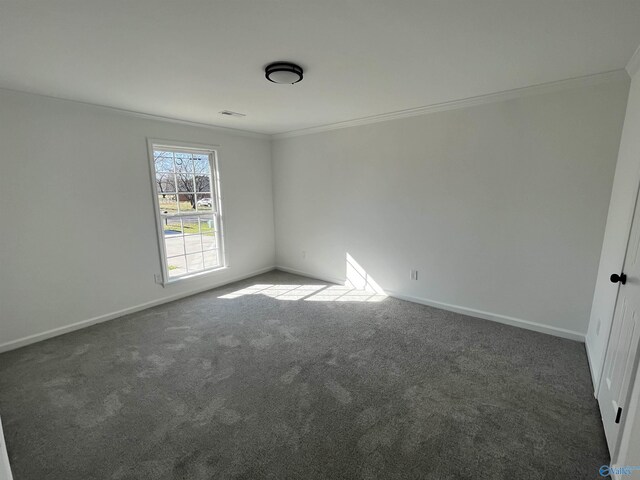 empty room with carpet floors, baseboards, and ornamental molding