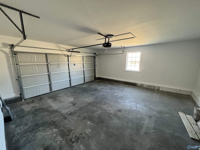 garage with a garage door opener and baseboards