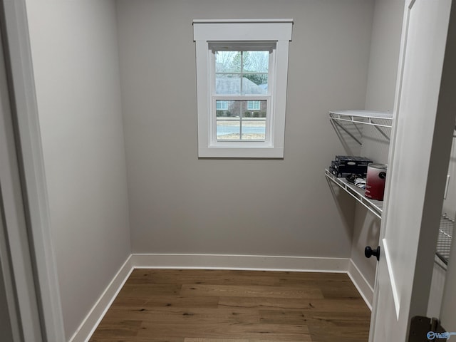 laundry room with dark wood-type flooring