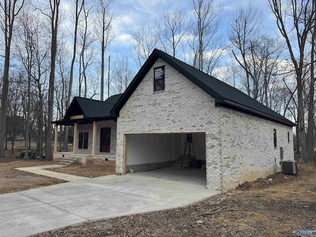 view of home's exterior featuring a garage, covered porch, and central air condition unit