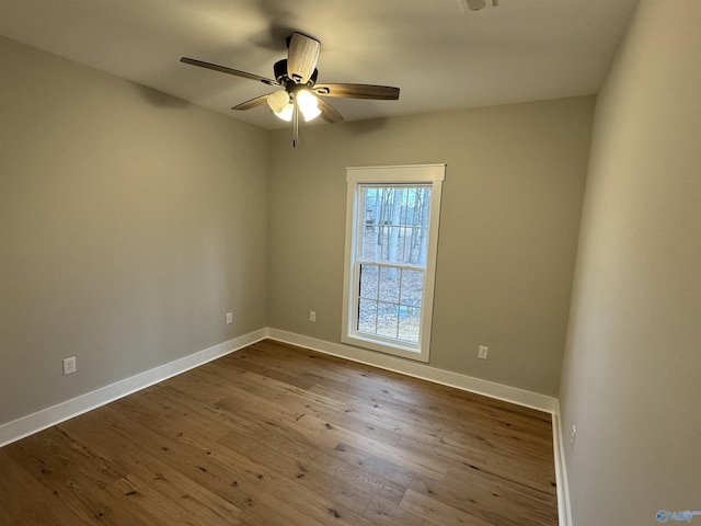 spare room with ceiling fan and wood-type flooring