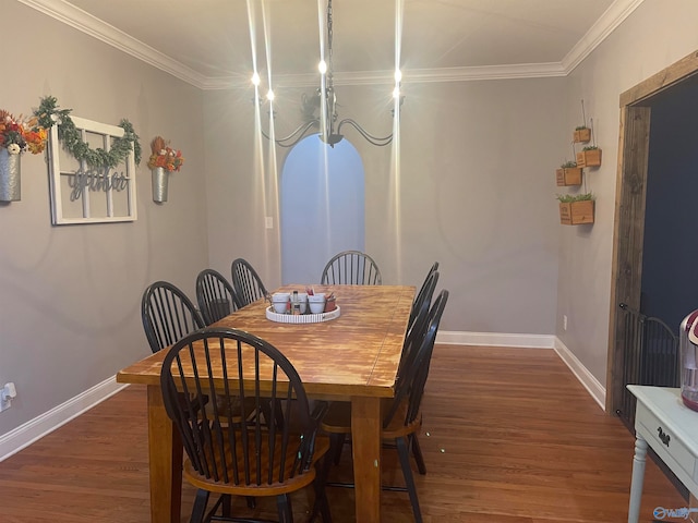 dining room with crown molding and dark hardwood / wood-style floors