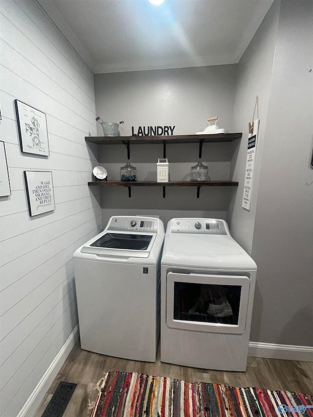 washroom featuring dark wood-type flooring and washer and dryer