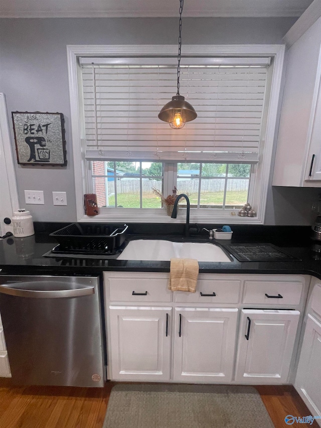 kitchen with dishwasher, pendant lighting, wood-type flooring, sink, and white cabinetry