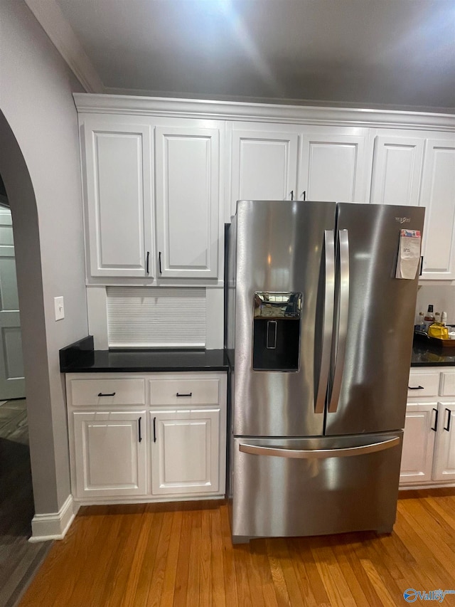 kitchen featuring light hardwood / wood-style floors, white cabinets, and stainless steel refrigerator with ice dispenser