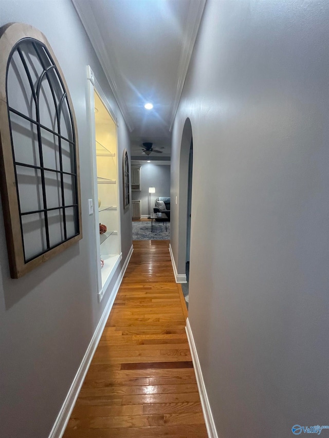 hall with ornamental molding and hardwood / wood-style flooring