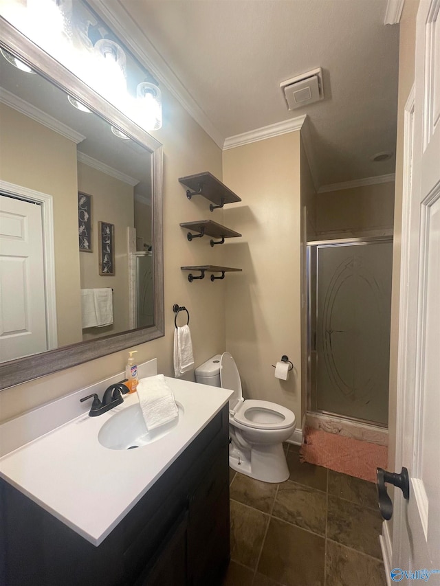 bathroom with tile patterned flooring, a shower with door, toilet, vanity, and ornamental molding