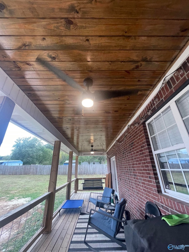 wooden terrace with a yard and ceiling fan